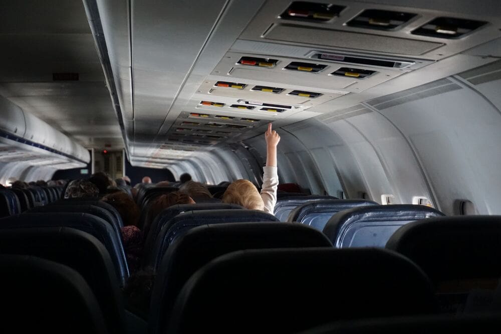 child pushing buttons on a plane