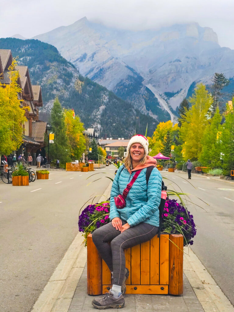 caz sitting on planter box in downtown banff