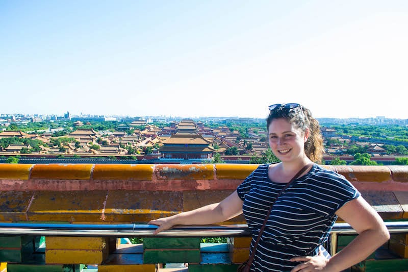 girl posing in front of view of Jingshan Park 