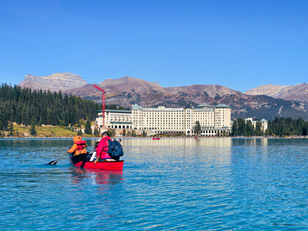 canoes on lake louise in front of fairmont chateau