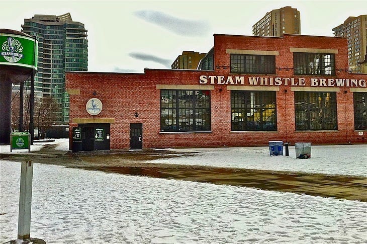 A sign in front of a brick building