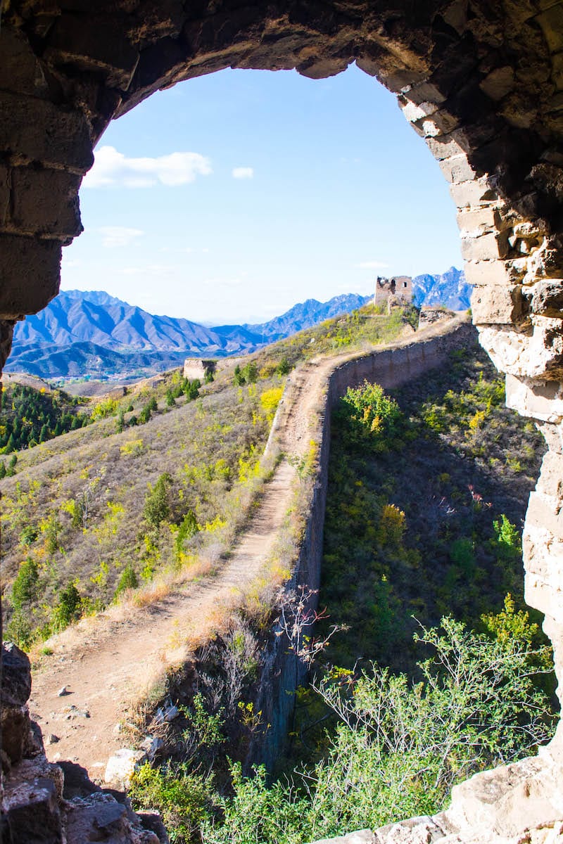 view of Great Wall of China through a rock wall hole