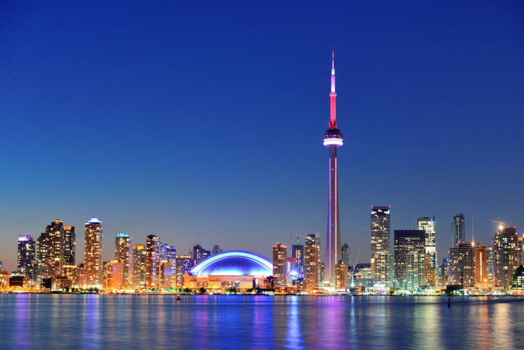 Toronto sunset over lake panorama with urban skyline.