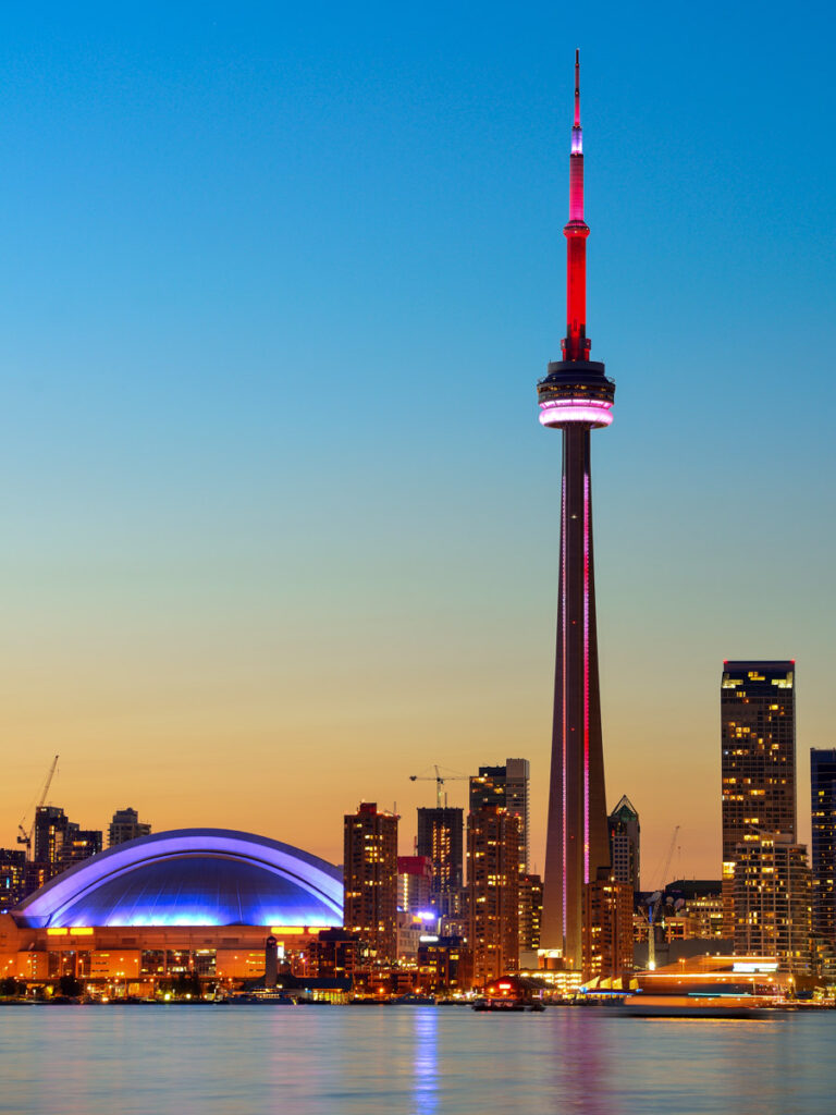 Toronto sunset over lake panorama with urban skyline.