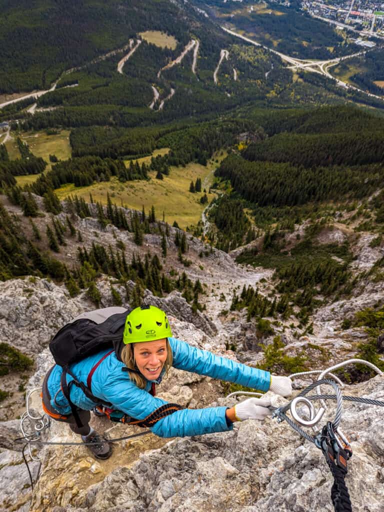 caz hanging off the side of the mountain in banff