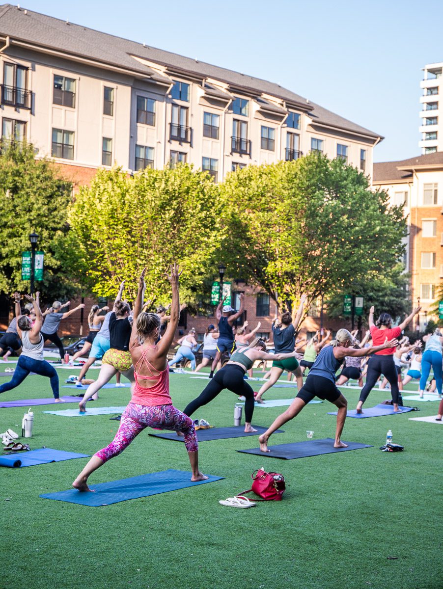 group of women doing yoga in the park