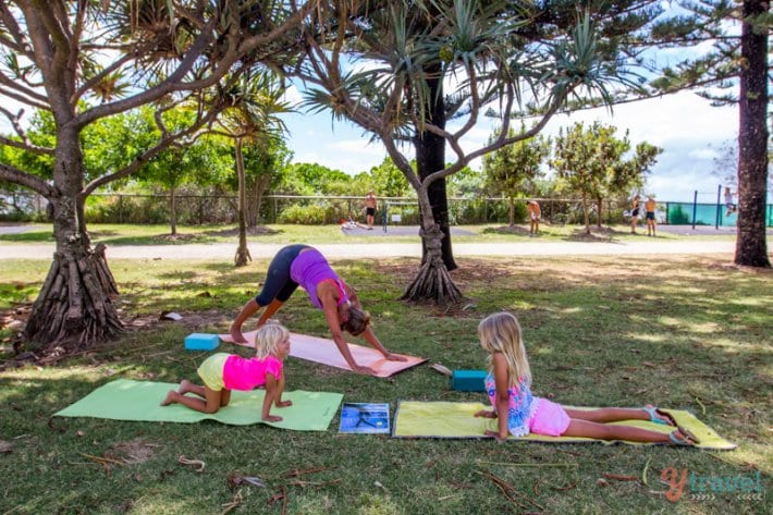 woman and child doing yoga in prk