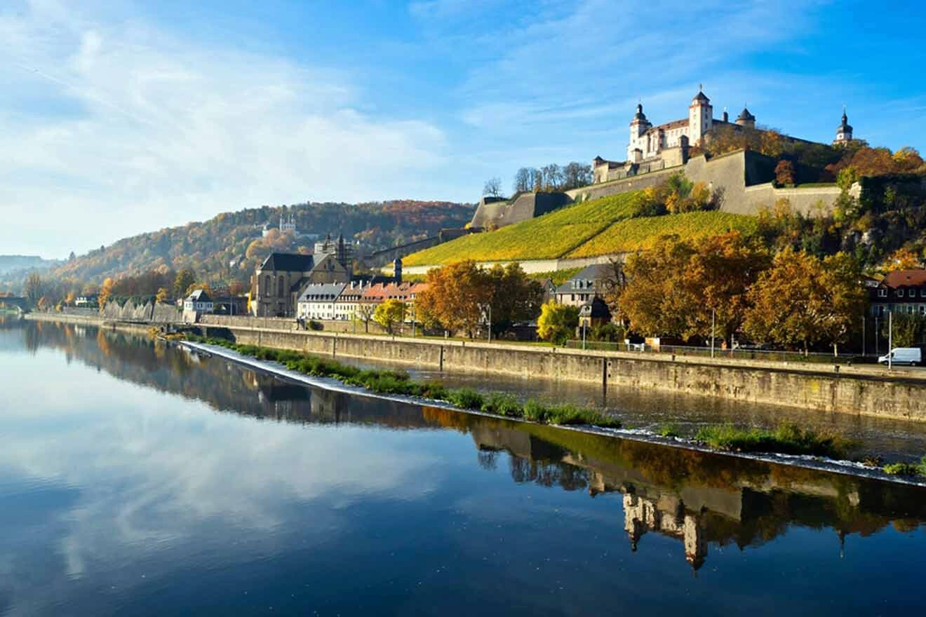 A castle is reflected in the water of a river.