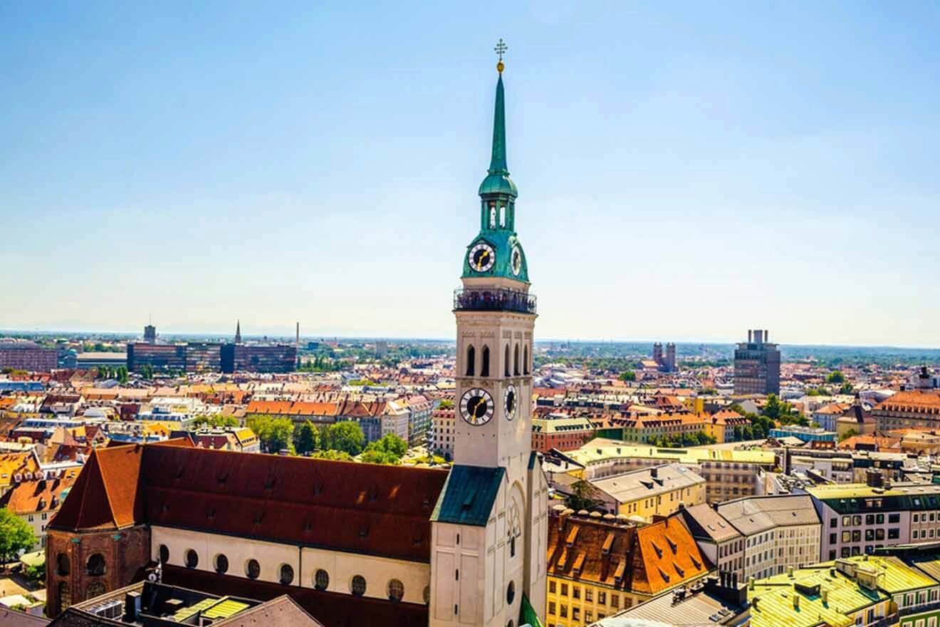 An aerial view of the city of munich with a church in the foreground