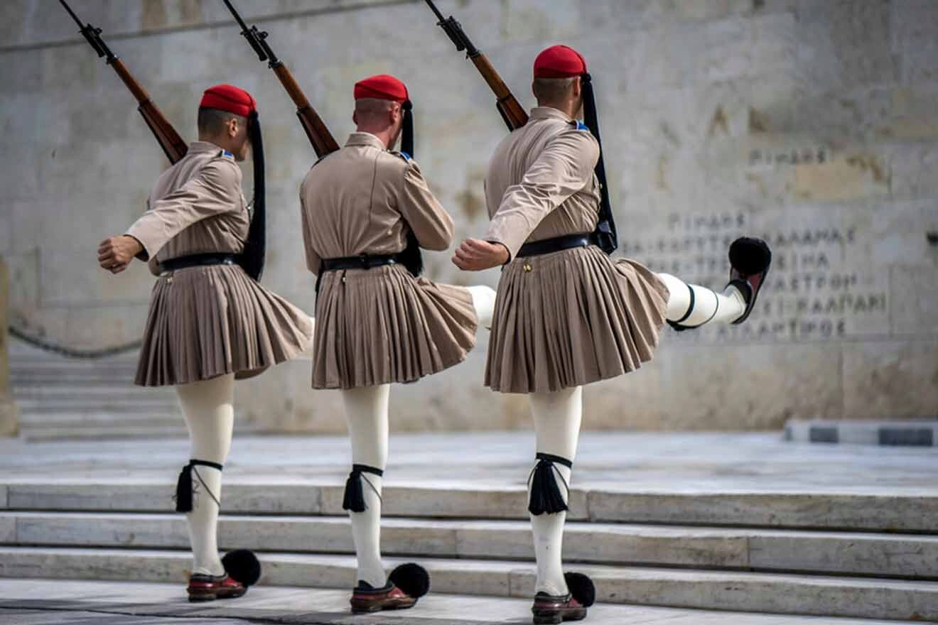 Three men in military uniforms standing on steps.