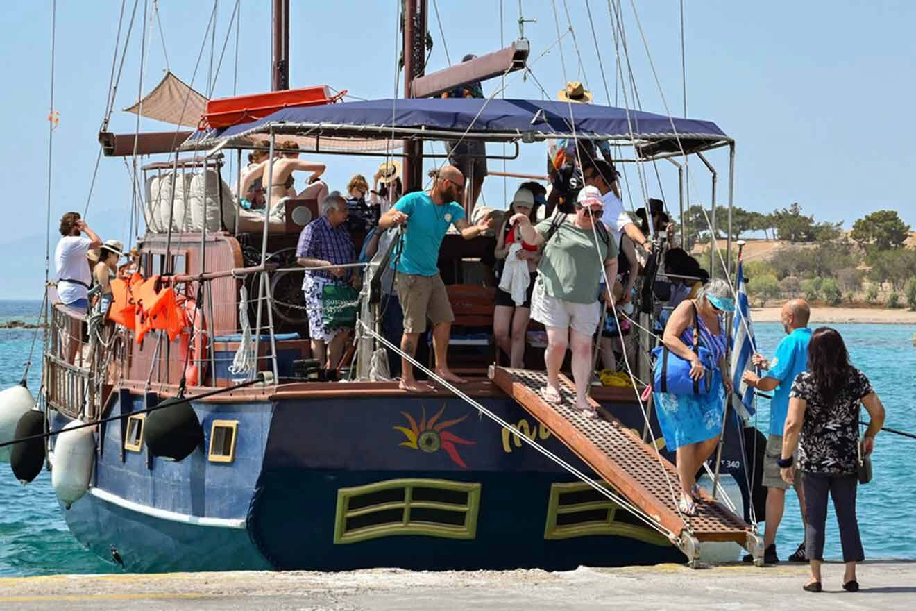 A group of people standing on the deck of a boat.