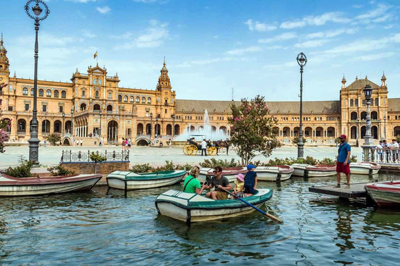 A group of people in boats in front of a large building.