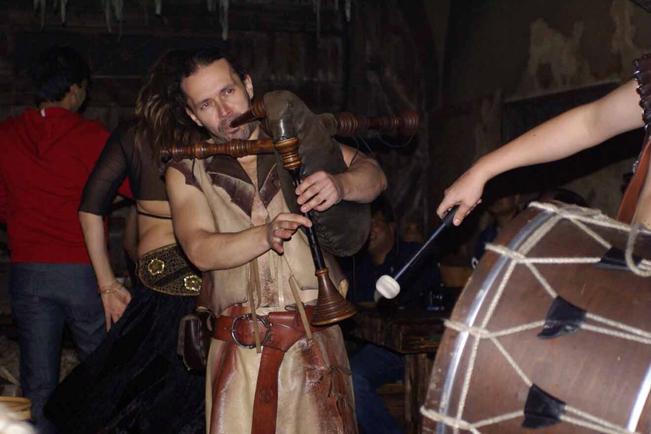 A group of people playing drums in a bar.