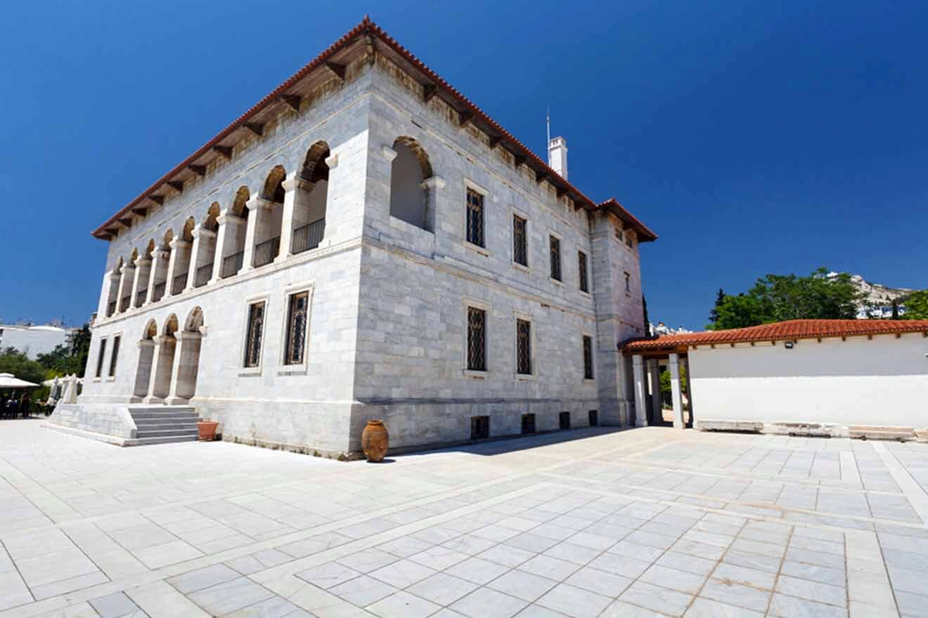 A large white building with arches in the courtyard.