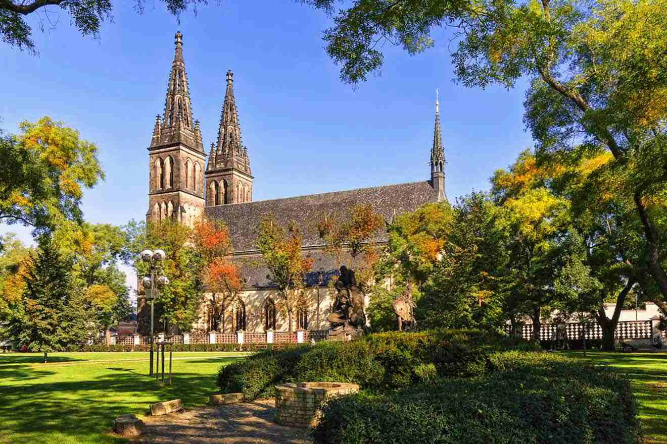 A church with spires in the middle of a park.