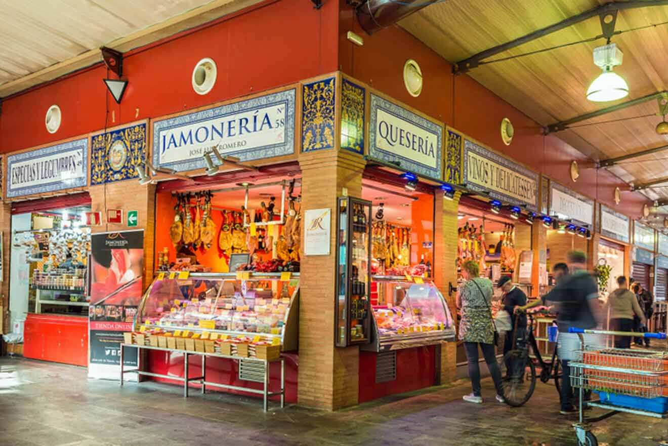 A large market with many people walking around.