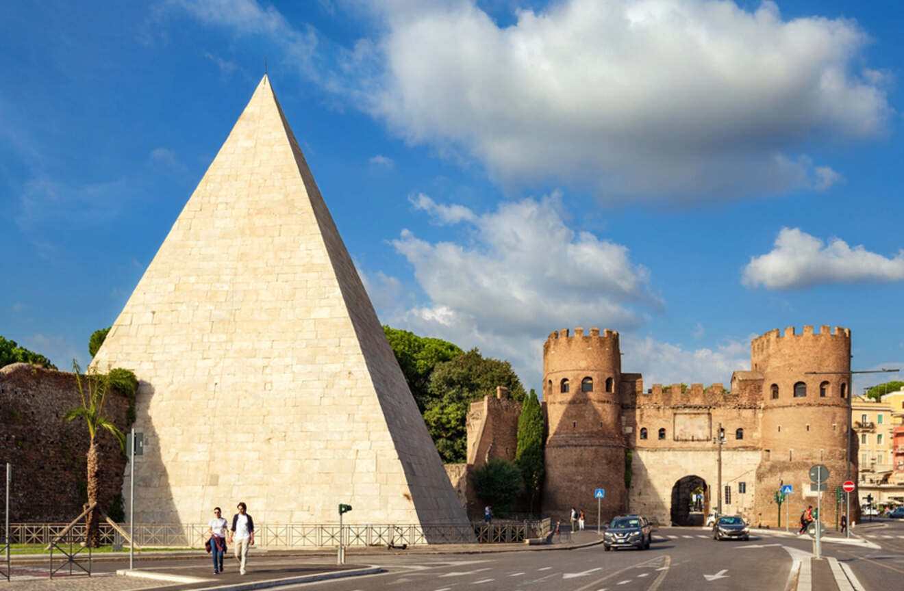 a pyramid next to an old gate