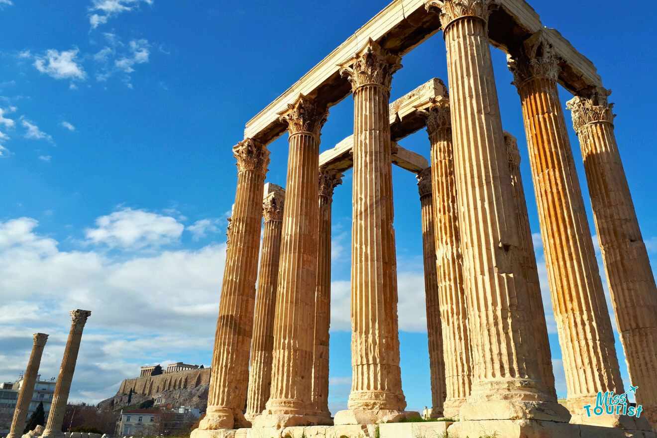 A group of pillars in front of a blue sky.