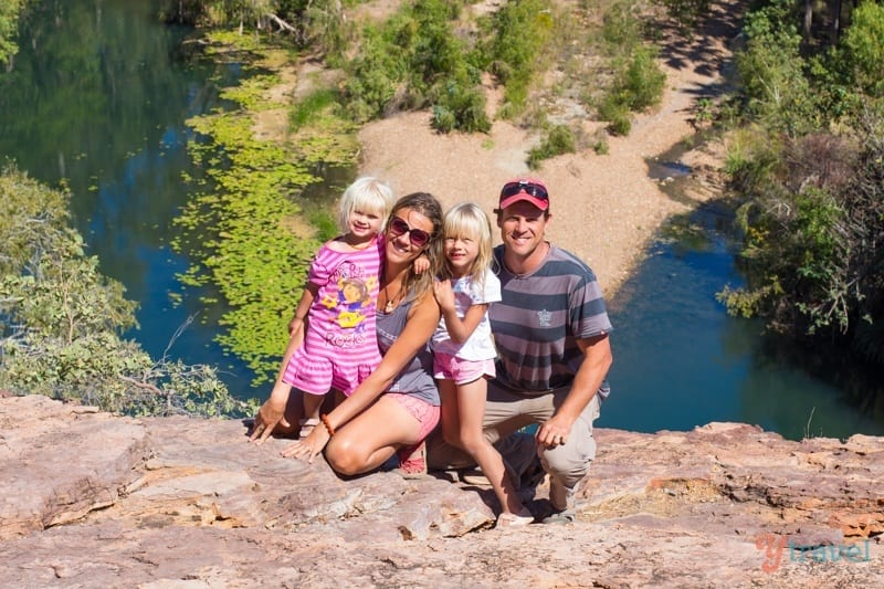 people sitting on a cliff