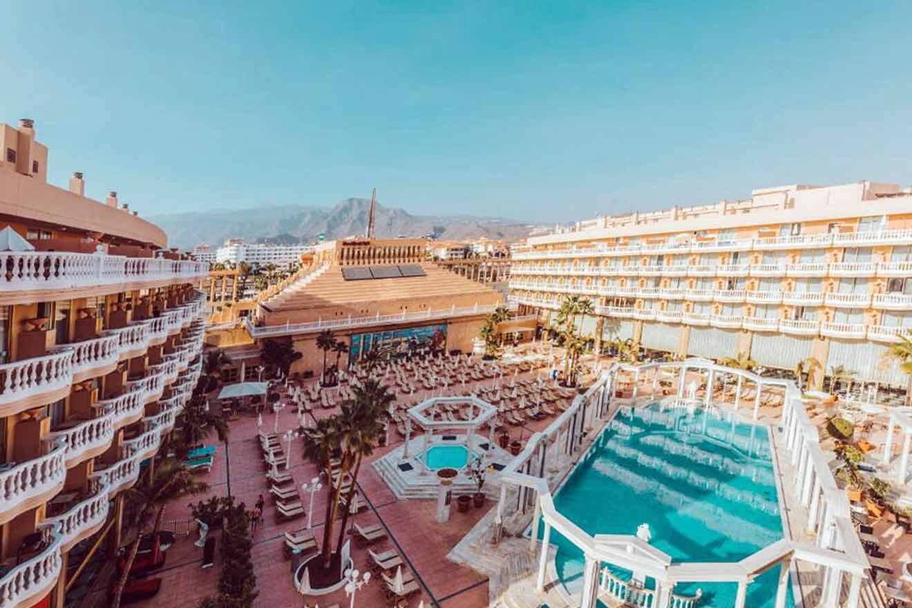 An aerial view of a hotel with a swimming pool.