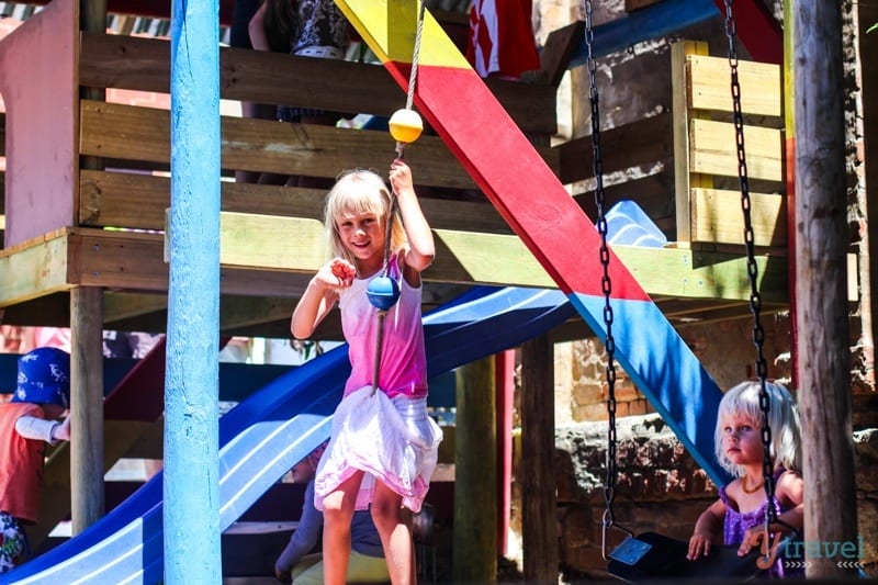 a girl playing on a playground