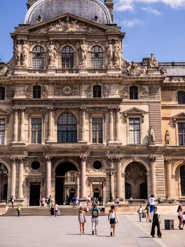 people walking in front of louvre