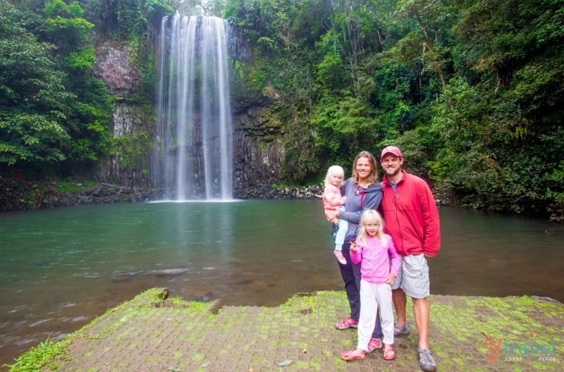 family posing in front of Millaa Milla Falls 