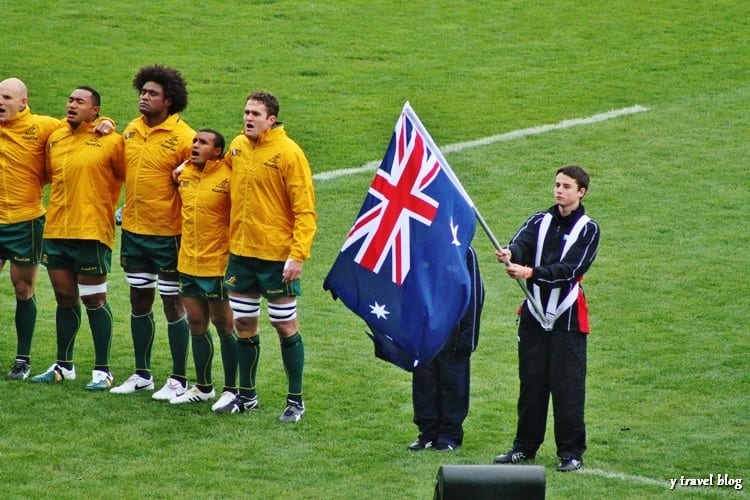 rugby players lined up next to australian flag