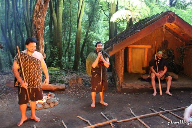 people standing in front of a cabin