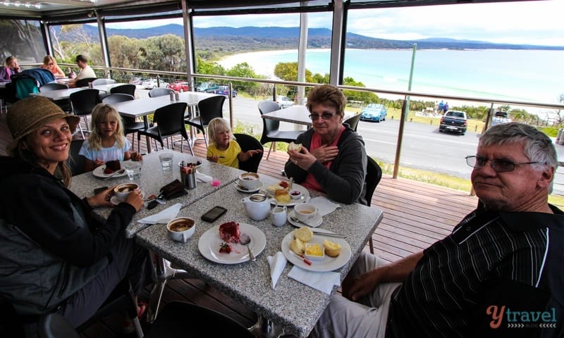 family sitting at table in restaurant with views of beach