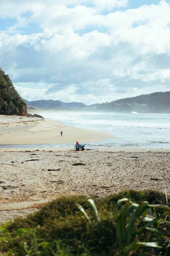 person walking on hot water beach new zealand