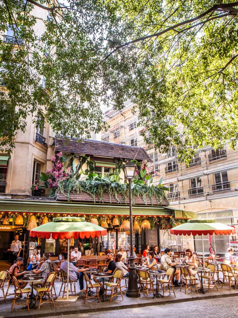 people sitting in paris cafe