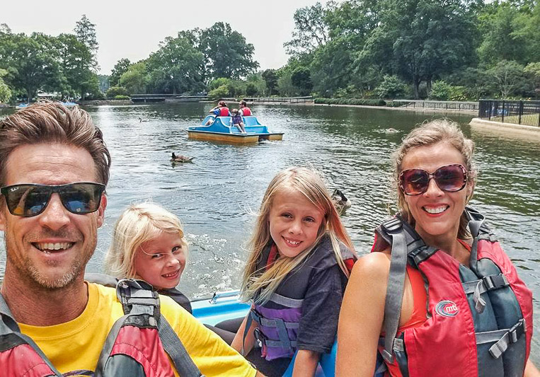 family in paddle board in pullen park