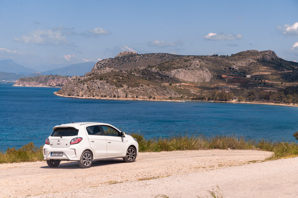 car by side of the road with coastline views