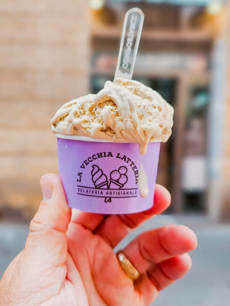 man holding cup of gelato