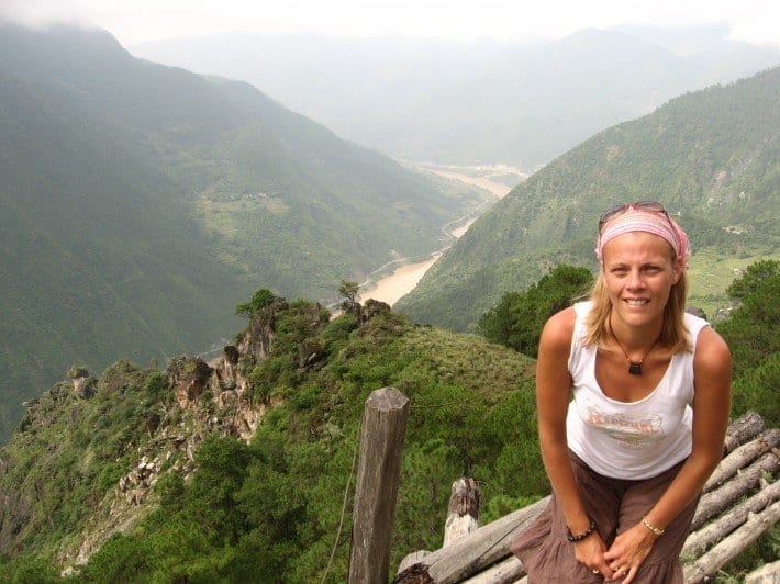 a woman standing on a mountain