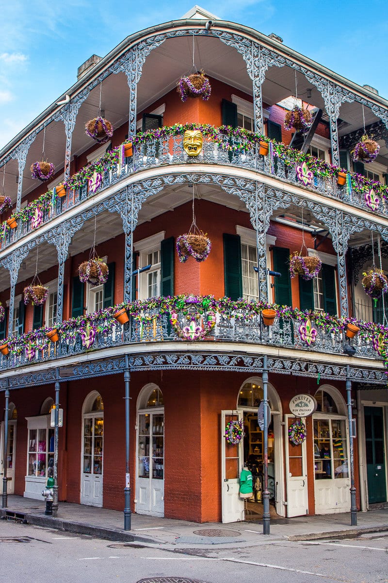 old building in nola with purple wreaths hanging off