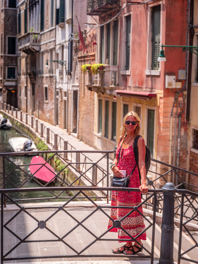 caroline standing on bridge over canal in venice