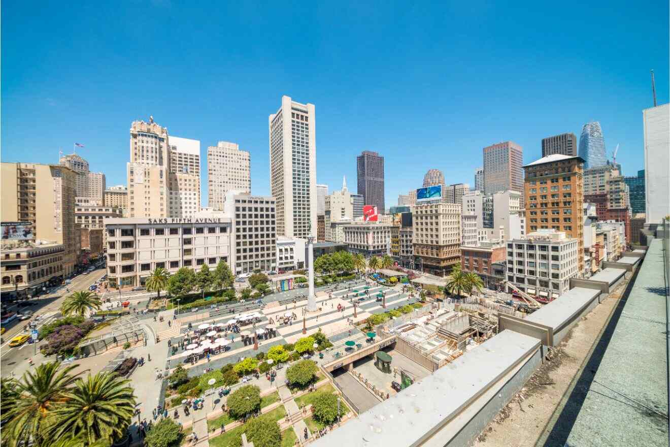 A bird's-eye view of Union Square in San Francisco, bustling with people and surrounded by a mix of classic and modern buildings under a clear blue sky