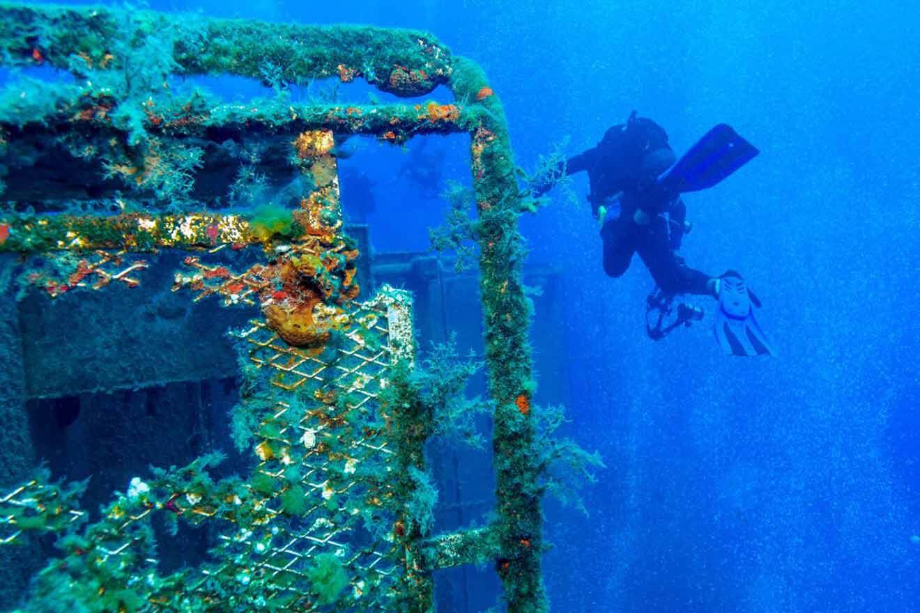 A scuba diver in the water near an old ship near Larnaca