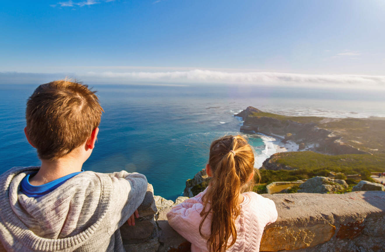 a girl and a boy overlooking a bay