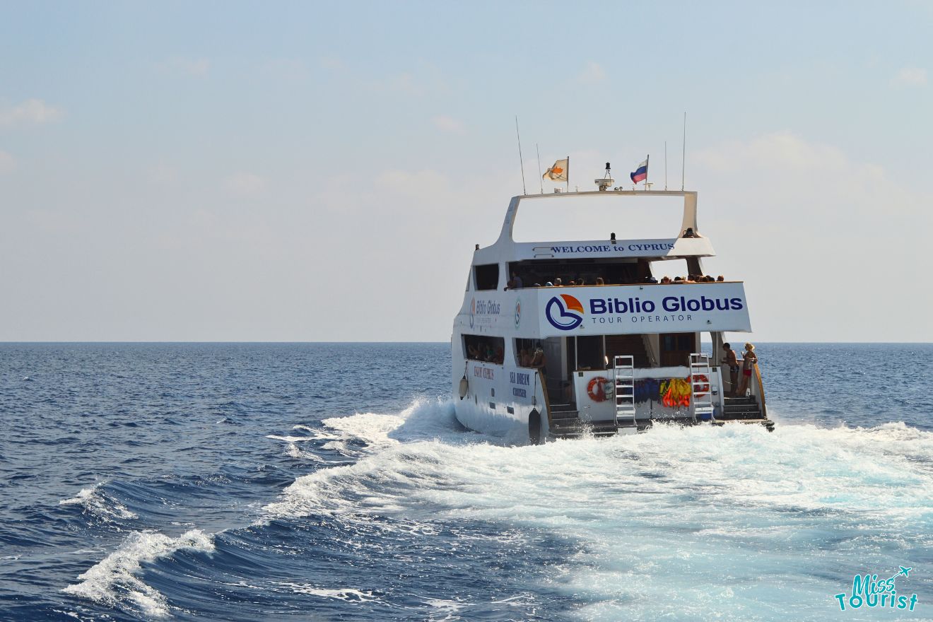 A boat traveling in the ocean with a sign on it.