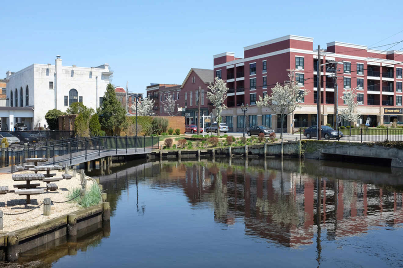 A waterway with a bridge and buildings in the background.