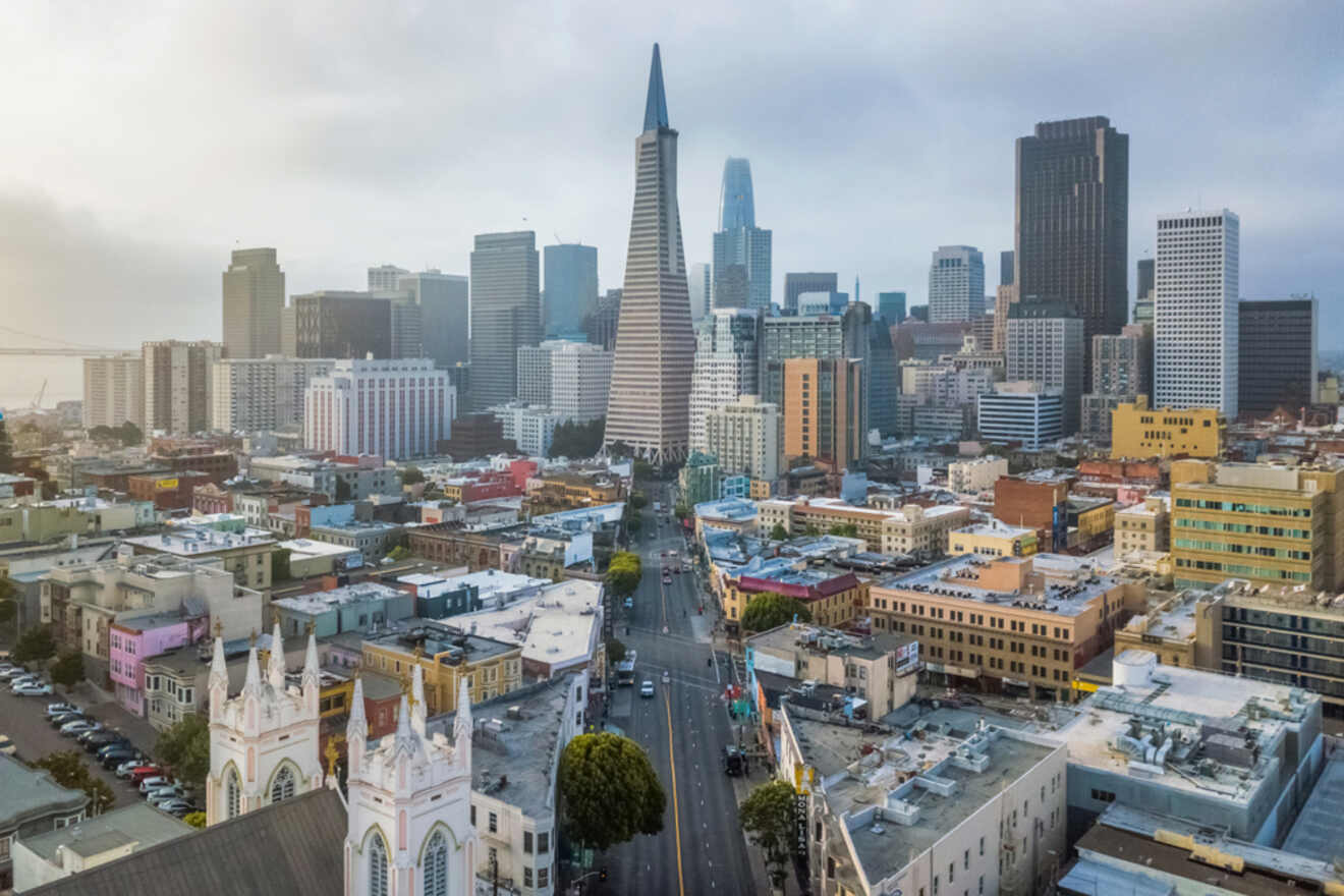 An aerial view of San Francisco's Embarcadero and Financial District, showcasing the city's dense skyscrapers and urban layout as a misty dawn breaks.