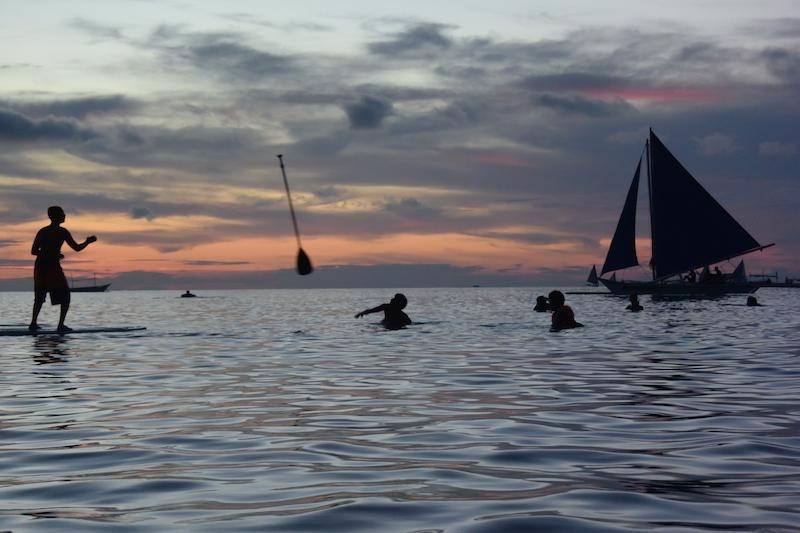 people swimming in Angol Beach the Philippines