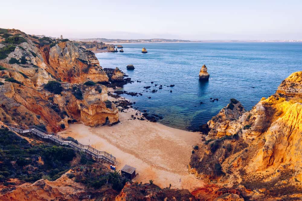 stairs leading down cliff face to Camilo Beach Portugal