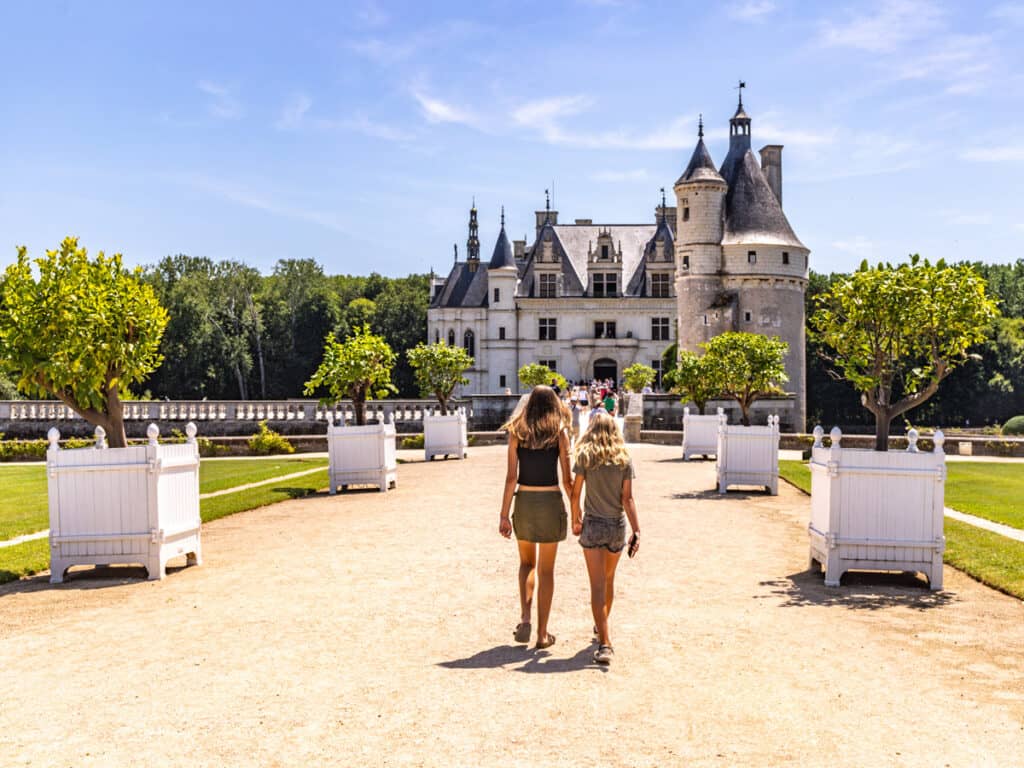 two girls walking up to Château de Chenonceau