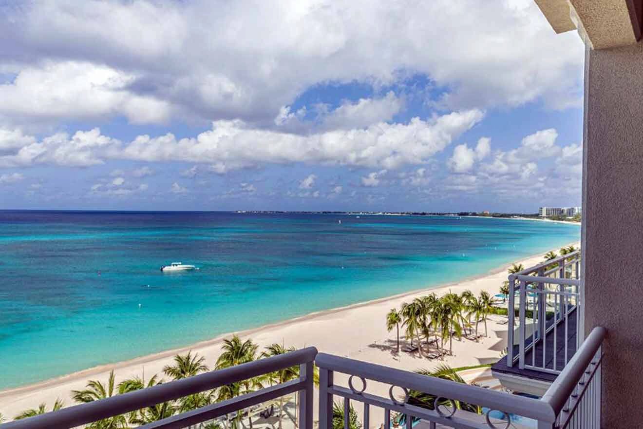 A balcony overlooking a beach and ocean.