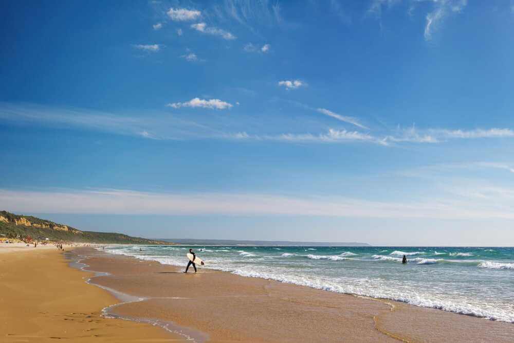 surfer walking out of water Fonte da Telha