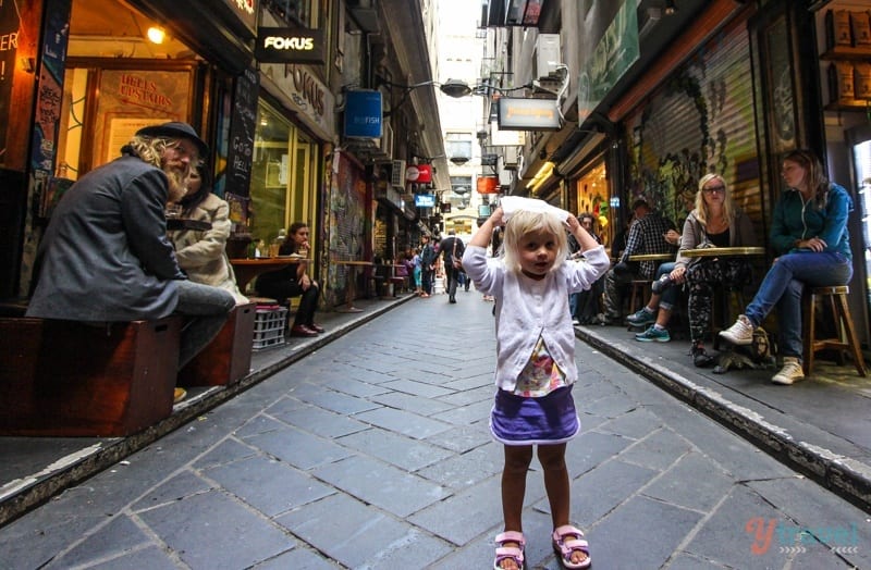 A little girl walking on a city street